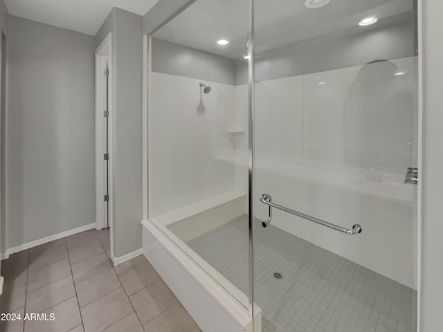 bathroom featuring tile patterned flooring and an enclosed shower