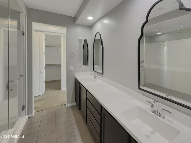 bathroom featuring tile patterned flooring, vanity, and an enclosed shower