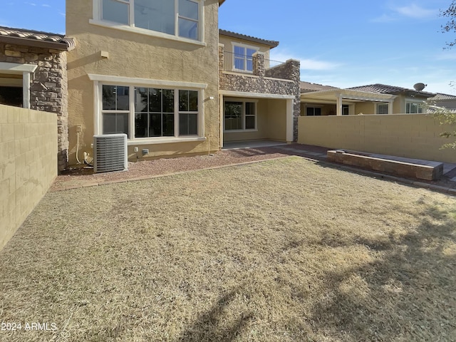 rear view of property featuring central air condition unit and a patio