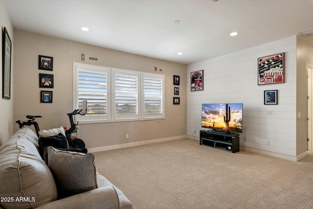 carpeted living area with baseboards and recessed lighting