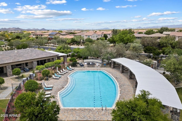 pool featuring fence, a mountain view, and a residential view