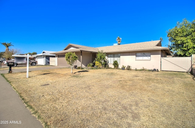 single story home with a front yard and a garage