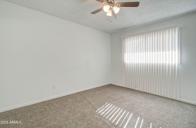 carpeted empty room featuring ceiling fan and a textured ceiling