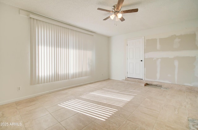 spare room featuring ceiling fan and a textured ceiling