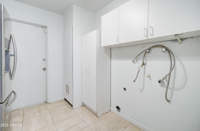 laundry area with cabinets, light tile patterned floors, and hookup for a washing machine