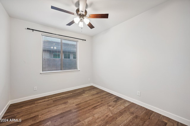 spare room with dark hardwood / wood-style floors and ceiling fan