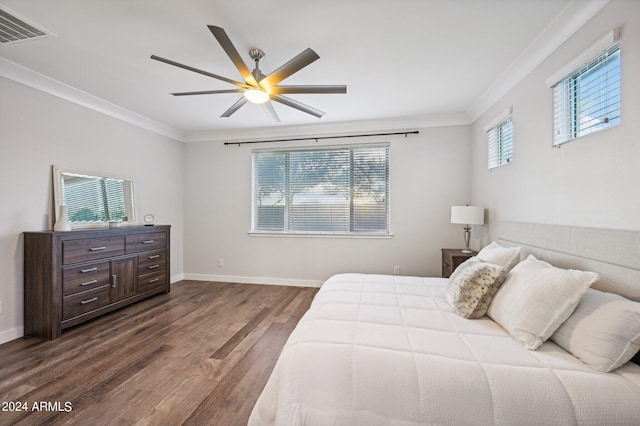 bedroom with multiple windows, ceiling fan, hardwood / wood-style floors, and ornamental molding