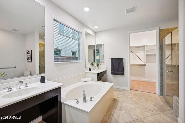 full bathroom with tile patterned flooring, shower with separate bathtub, vanity, and toilet