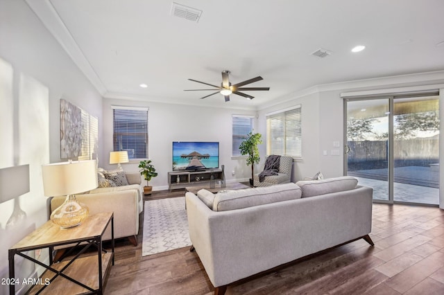 living room featuring dark hardwood / wood-style floors, ceiling fan, and crown molding