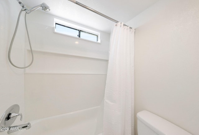 full bath with shower / bath combo with shower curtain and toilet