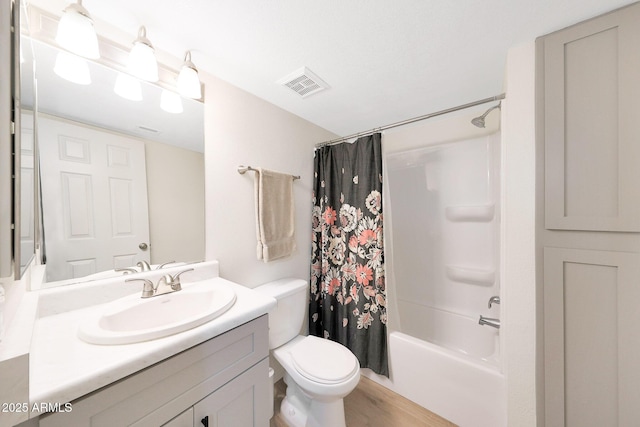 bathroom featuring toilet, vanity, shower / bath combination with curtain, and wood finished floors