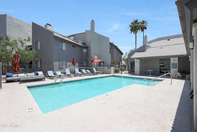 community pool with a patio area