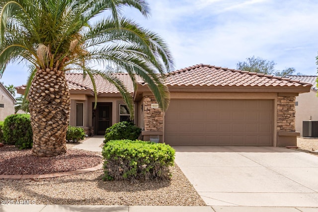 16331 W Tierra Way, Surprise, AZ 85374 - view of front of home featuring stone siding, a tiled roof, a garage, concrete driveway, and stucco siding