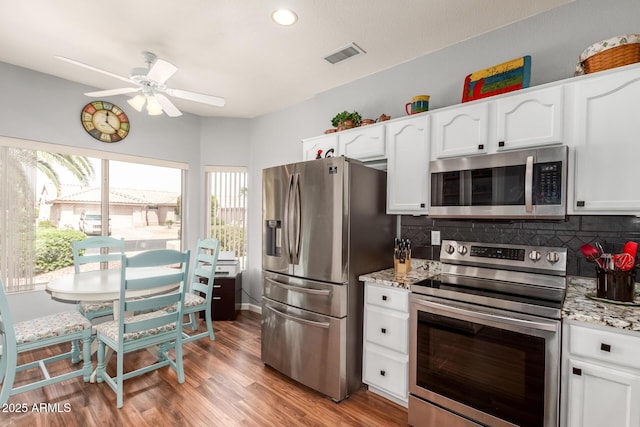 16331 W Tierra Way, Surprise, AZ 85374 - kitchen with visible vents, a ceiling fan, backsplash, and stainless steel appliances