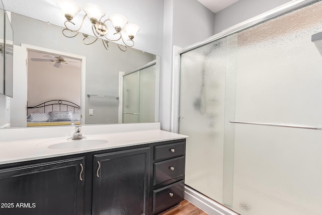 16331 W Tierra Way, Surprise, AZ 85374 - ensuite bathroom with a stall shower, vanity, a chandelier, wood finished floors, and ensuite bathroom