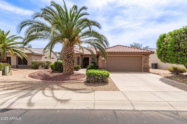 16331 W Tierra Way, Surprise, AZ 85374 - view of front facade featuring driveway, stone siding, stucco siding, a tiled roof, and a garage