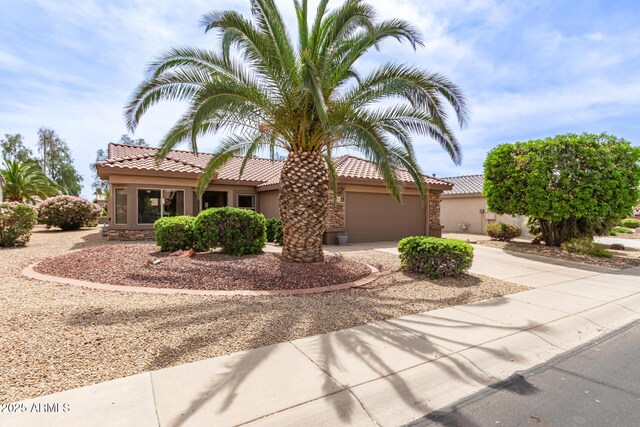 16331 W Tierra Way, Surprise, AZ 85374 - view of front facade featuring a tile roof, stucco siding, an attached garage, and concrete driveway