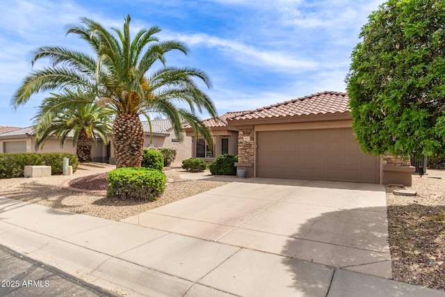 16331 W Tierra Way, Surprise, AZ 85374 - mediterranean / spanish-style home featuring a tile roof, stucco siding, an attached garage, stone siding, and driveway