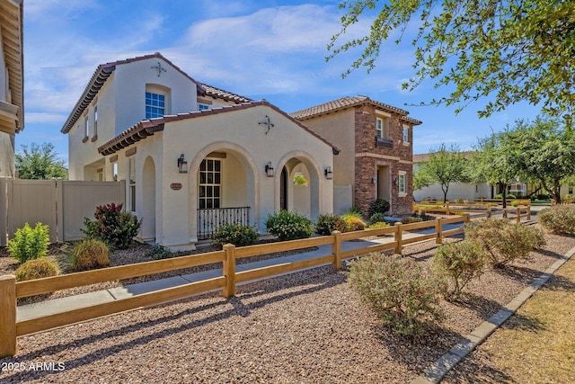 3828 S Verbena Ave, Gilbert, AZ 85297 - mediterranean / spanish-style home featuring a fenced front yard, covered porch, stucco siding, and a tile roof
