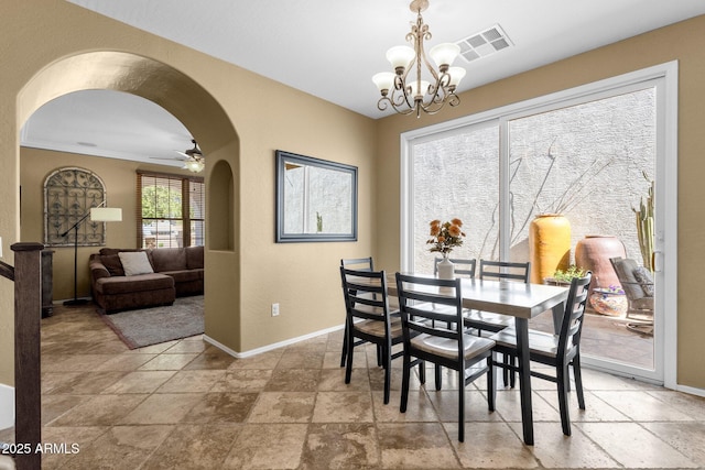 3828 S Verbena Ave, Gilbert, AZ 85297 - dining space featuring visible vents, arched walkways, baseboards, and stone tile floors