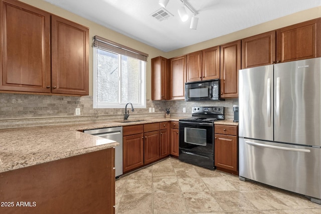 3828 S Verbena Ave, Gilbert, AZ 85297 - kitchen featuring brown cabinetry, visible vents, tasteful backsplash, a sink, and black appliances