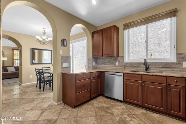 3828 S Verbena Ave, Gilbert, AZ 85297 - kitchen with a sink, arched walkways, decorative backsplash, a healthy amount of sunlight, and stainless steel dishwasher