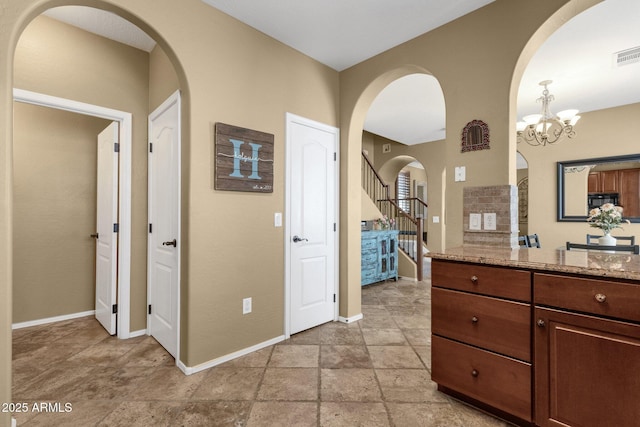 3828 S Verbena Ave, Gilbert, AZ 85297 - bathroom with stone finish floor, visible vents, baseboards, vanity, and a chandelier