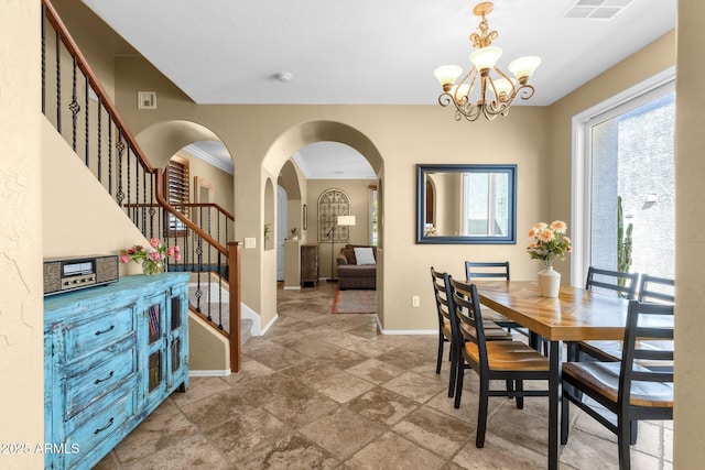 3828 S Verbena Ave, Gilbert, AZ 85297 - dining room featuring an inviting chandelier, arched walkways, baseboards, visible vents, and stairway