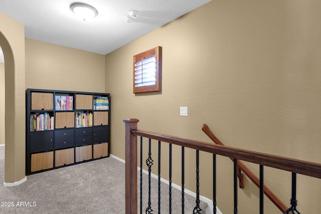 3828 S Verbena Ave, Gilbert, AZ 85297 - hallway featuring baseboards, carpet flooring, arched walkways, and an upstairs landing