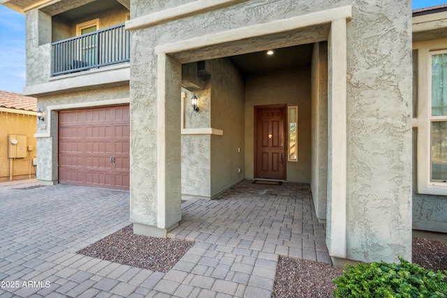 doorway to property with a balcony and a garage