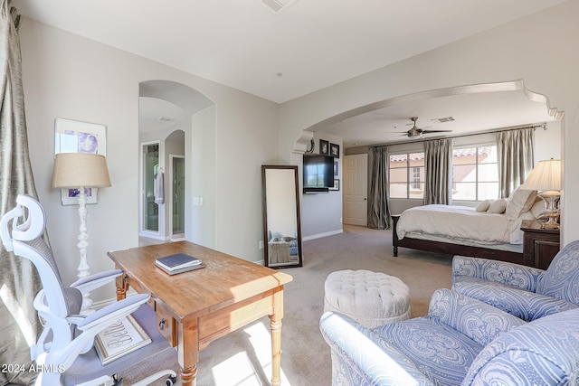 bedroom featuring baseboards, arched walkways, and light colored carpet