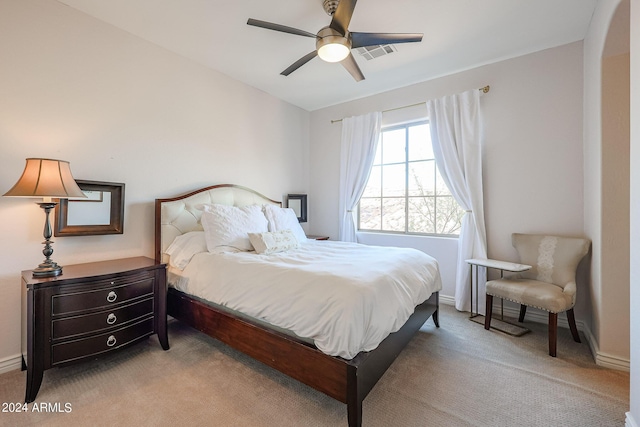 bedroom with baseboards, visible vents, ceiling fan, and light colored carpet