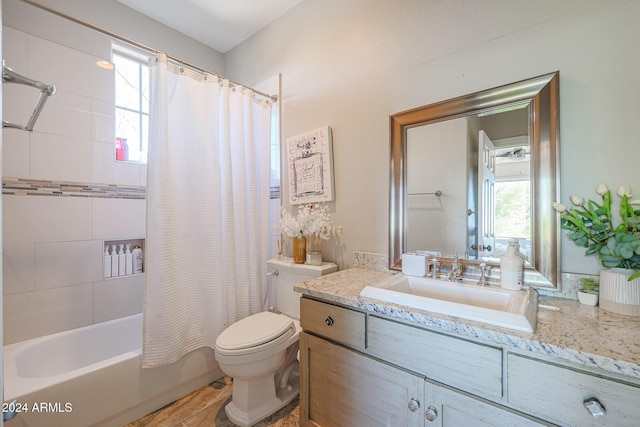 full bathroom with vanity, shower / bath combo with shower curtain, and toilet