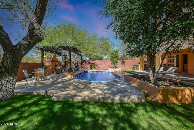 view of pool with a fenced backyard, an outdoor stone fireplace, and a patio