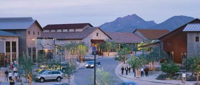 view of street featuring curbs, sidewalks, and a mountain view