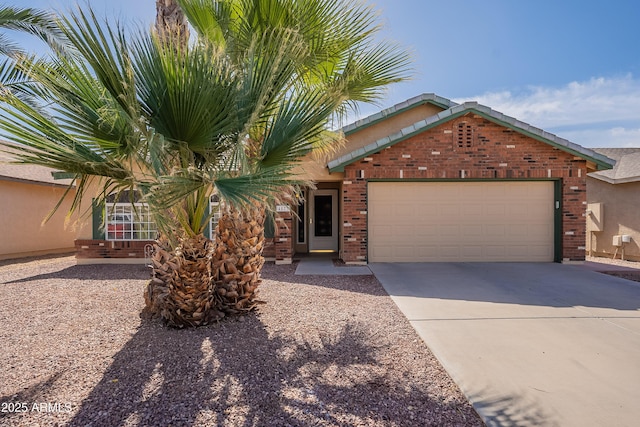 view of front of property featuring brick siding, driveway, and an attached garage