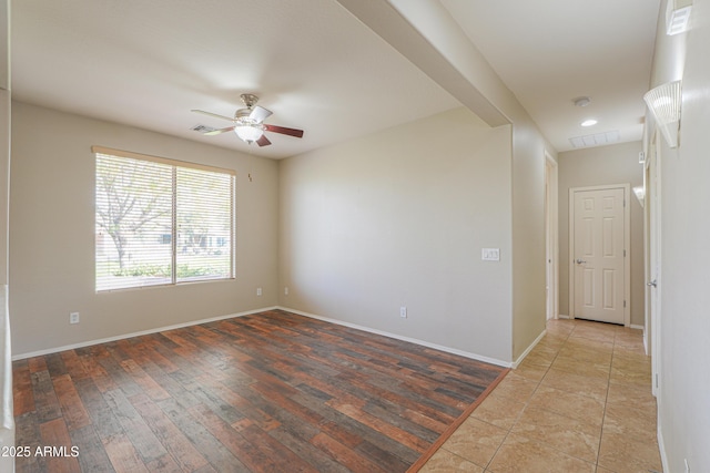 unfurnished room with light wood-type flooring and ceiling fan