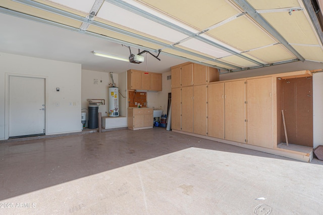 garage featuring water heater and a garage door opener