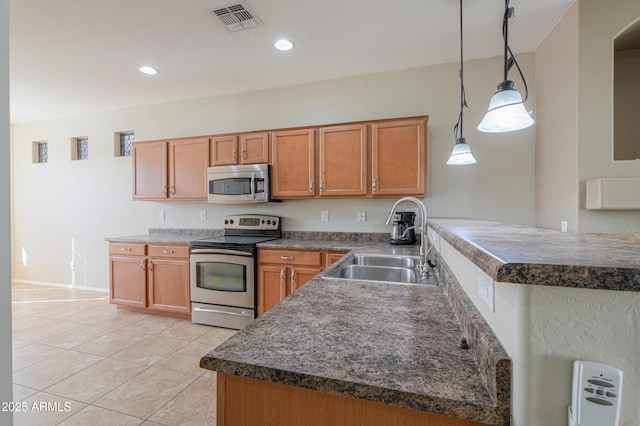 kitchen featuring light tile patterned floors, kitchen peninsula, stainless steel appliances, pendant lighting, and sink