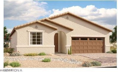 mediterranean / spanish house featuring a garage, driveway, and stucco siding