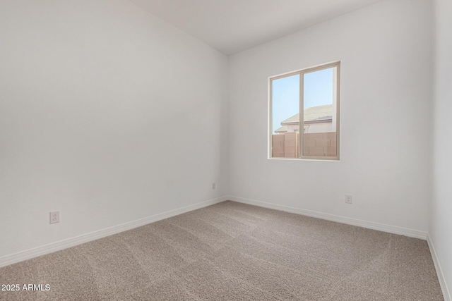 empty room with carpet floors and baseboards