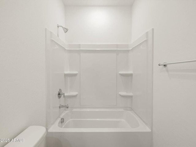 bathroom featuring toilet and bathing tub / shower combination