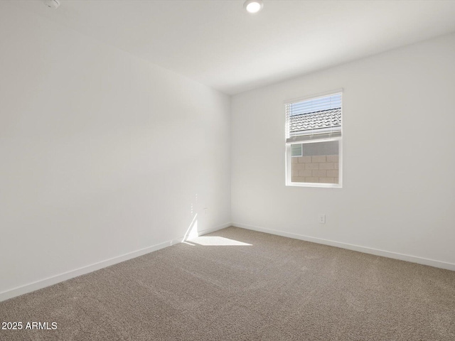spare room with carpet floors and baseboards