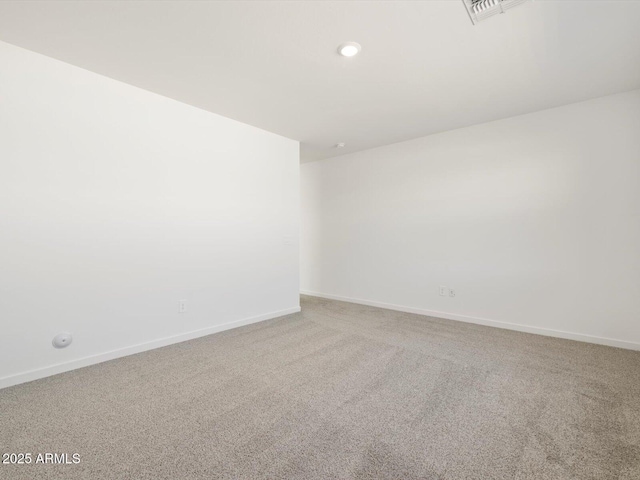 carpeted empty room with baseboards, recessed lighting, and visible vents