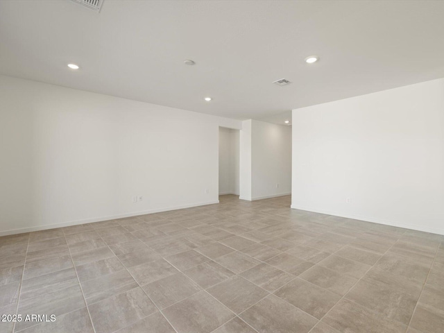 empty room with recessed lighting, baseboards, and visible vents
