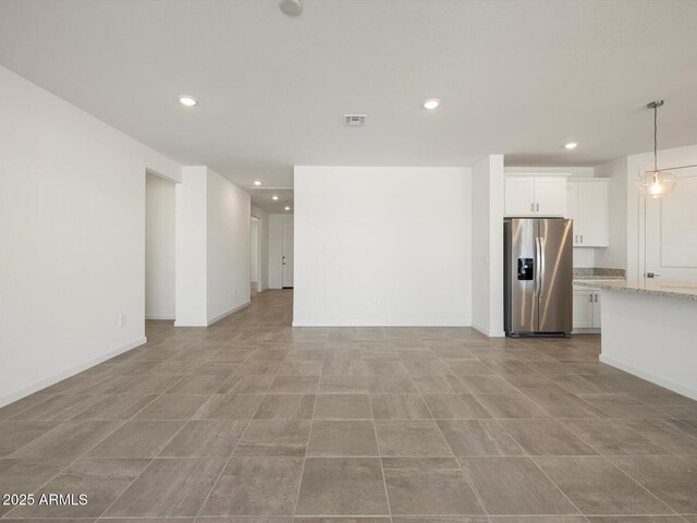 unfurnished living room with recessed lighting and visible vents