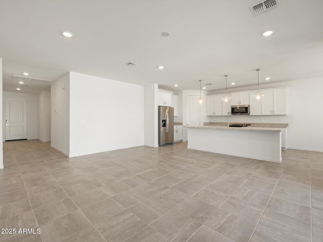 kitchen featuring appliances with stainless steel finishes, recessed lighting, open floor plan, white cabinetry, and visible vents