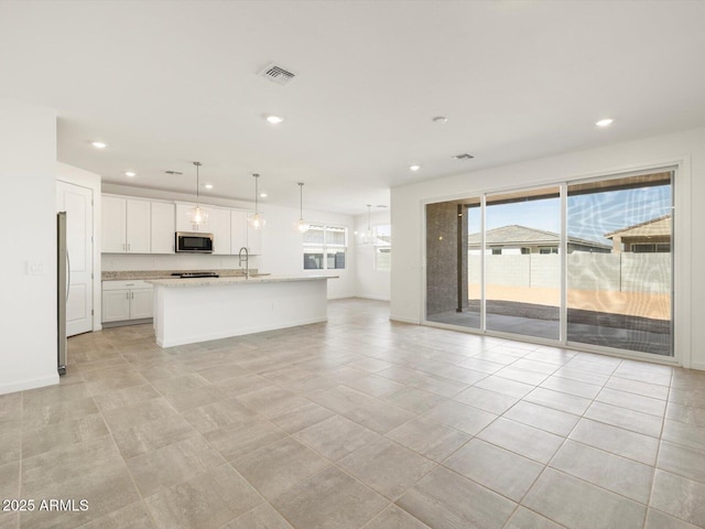 unfurnished living room featuring visible vents, a sink, baseboards, recessed lighting, and light tile patterned flooring