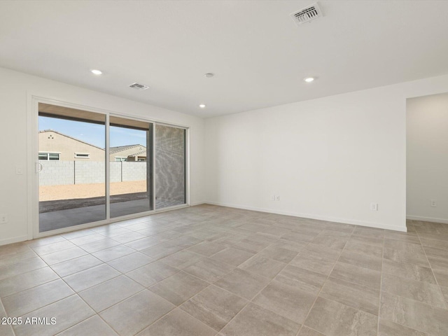 empty room with light tile patterned floors, baseboards, visible vents, and recessed lighting