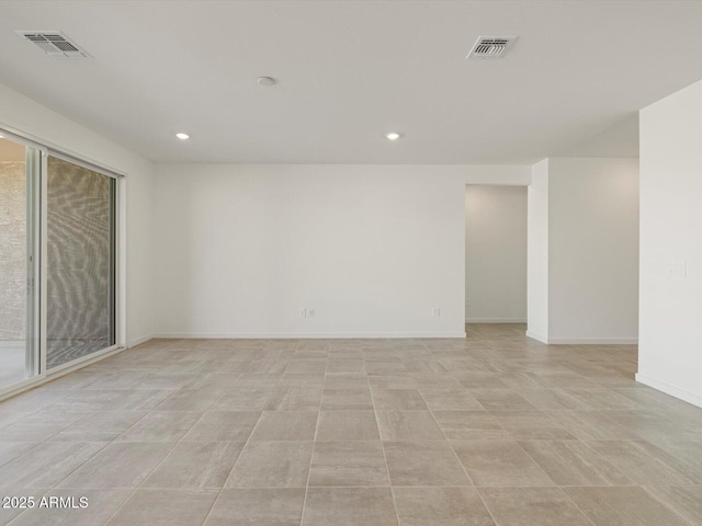 spare room with recessed lighting, visible vents, and baseboards